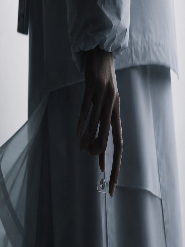 A person holding the m.2 sensor between their fingers.
